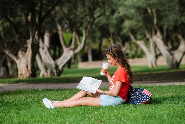 Happy female tourist relaxing in park