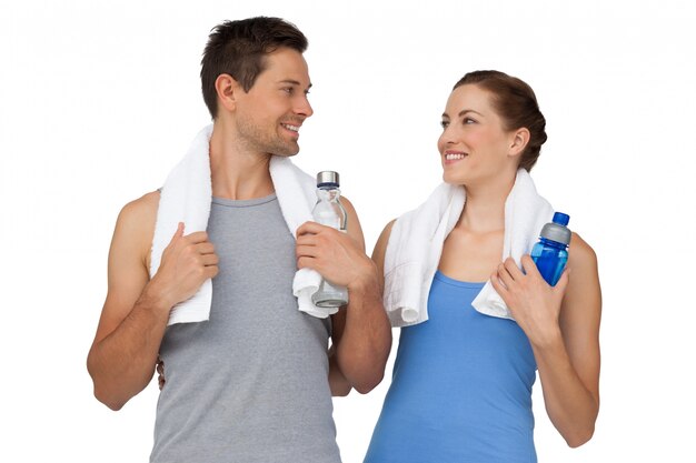 Happy fit young couple with water bottles