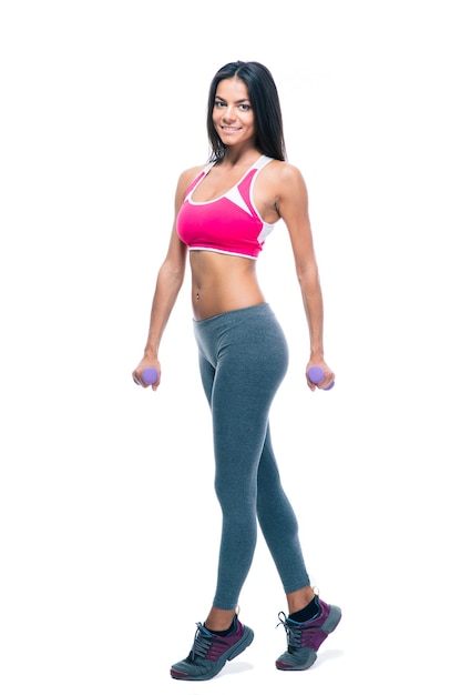 Happy fitness woman holding dumbbells