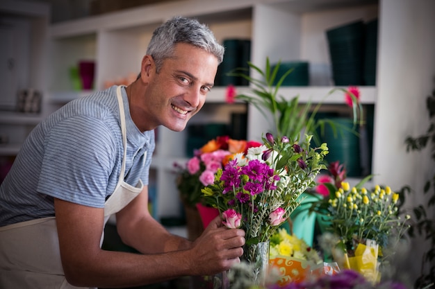 Happy florist preparing a flower bouquet