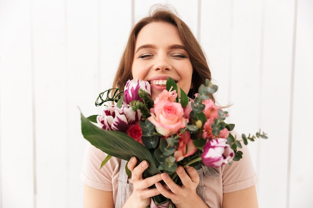 Happy florist woman standing with flowers