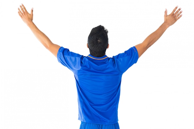 Happy football player in blue celebrating