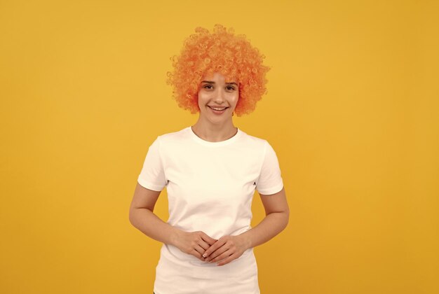 Happy freaky woman in curly clown wig for party fun