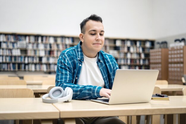 A happy freelancer looking at the screen while creating a project for a new project Portrait