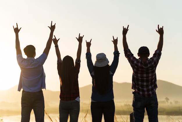 Happy friends are having fun with raised arms together, Friendship concept.