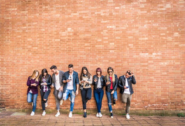 Happy friends of a brick wall