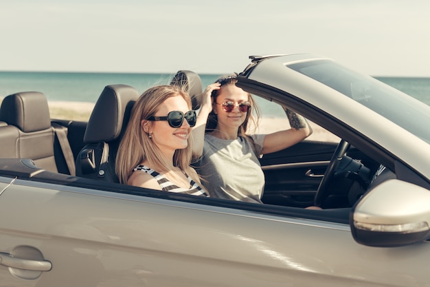 Happy friends in car