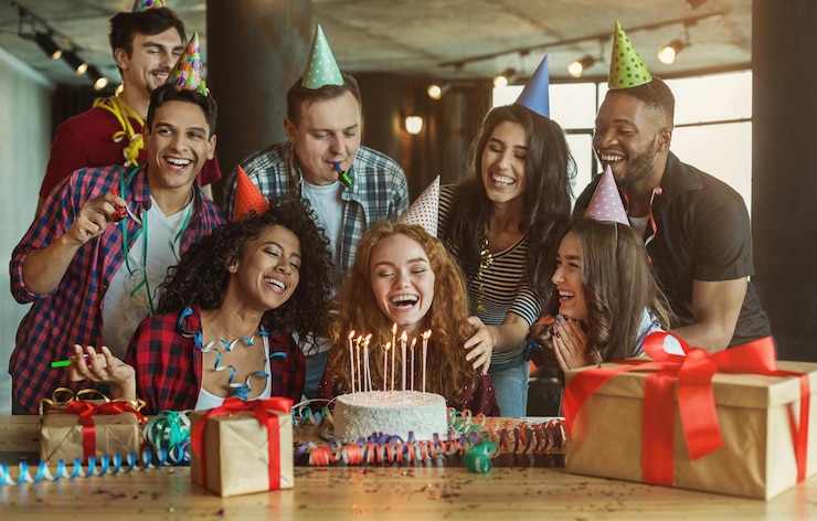 Photo happy friends congratulating girl on surprise birthday party, copy space
