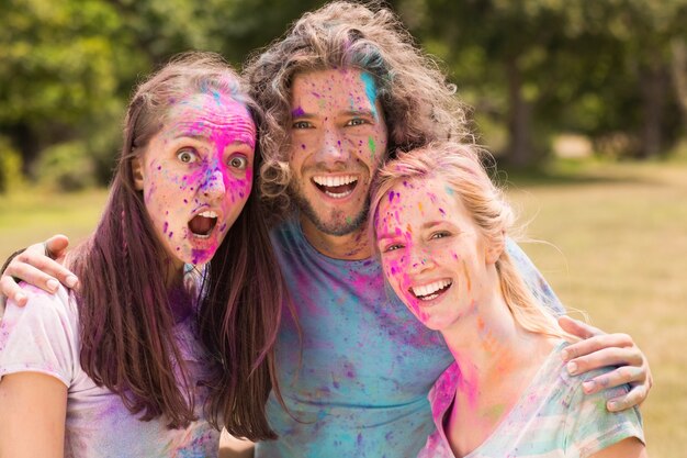 Happy friends covered in powder paint