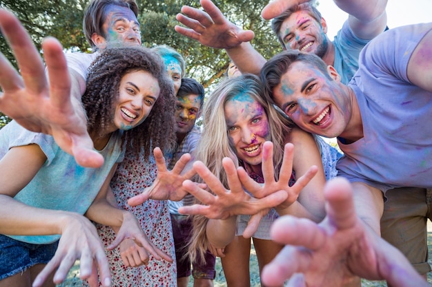 Happy friends covered in powder paint