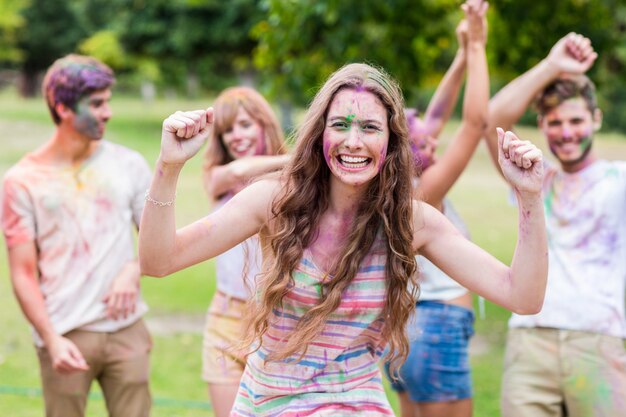 Happy friends covered in powder paint