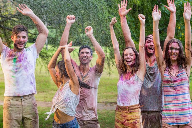 Happy friends covered in powder paint