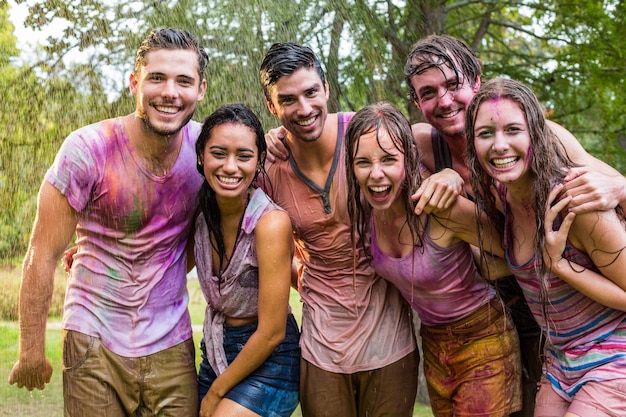 Happy friends covered in powder paint