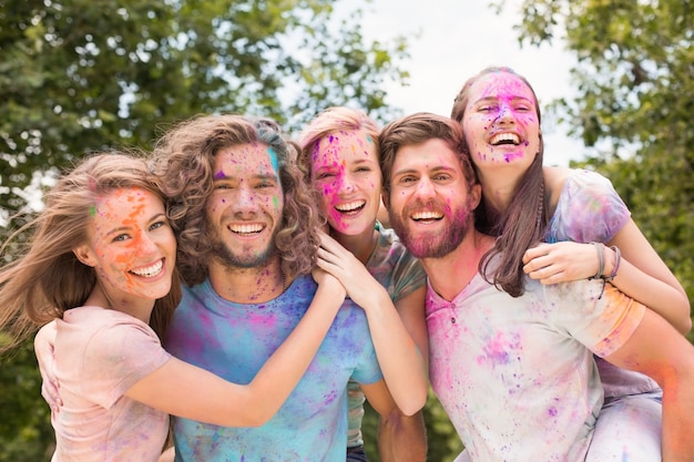 Happy friends covered in powder paint