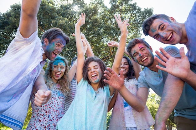 Happy friends covered in powder paint