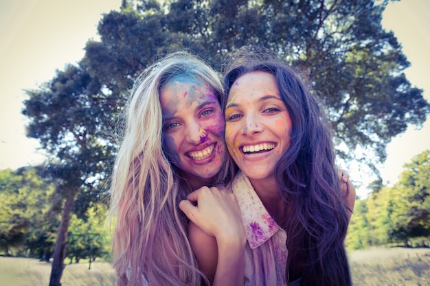 Happy friends covered in powder paint