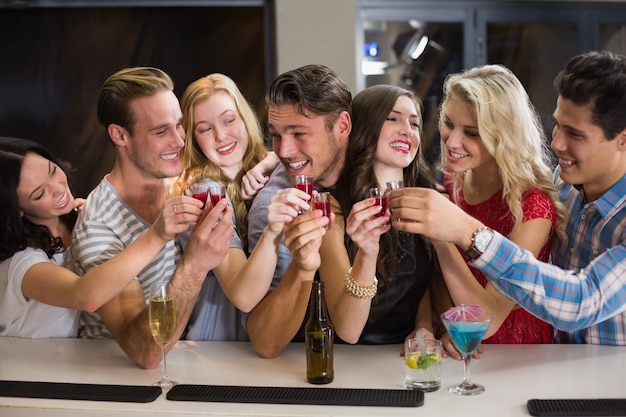 Happy friends having a drink together