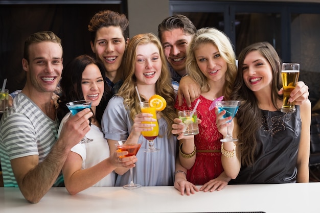 Happy friends having a drink together