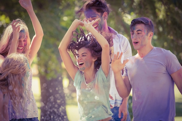 Happy friends having fun with powder paint