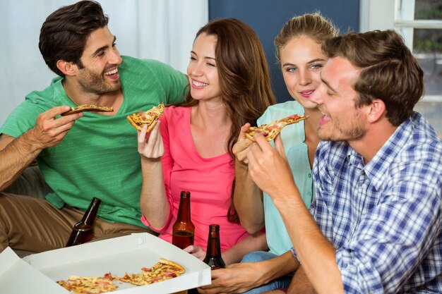 Happy friends having pizza