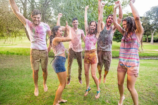 Happy friends jumping in the water shoot