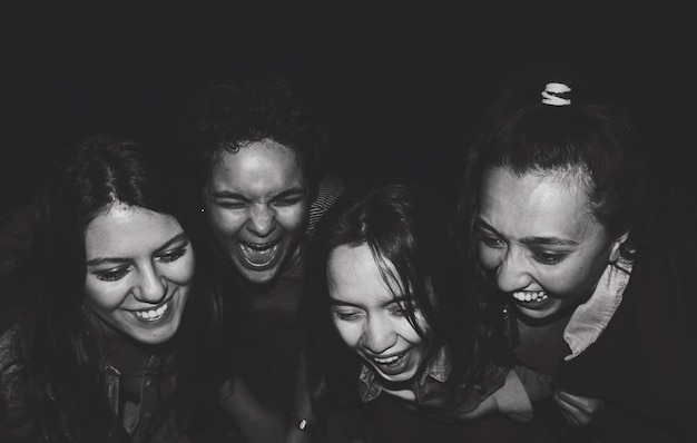 happy friends looking down in darkroom