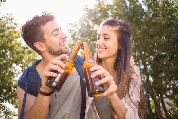 Happy friends in the park having beers