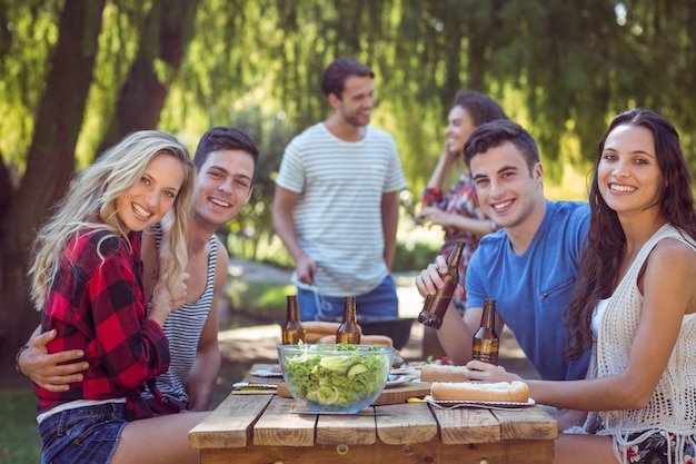 Happy friends in the park having lunch