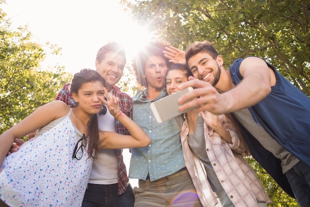 Happy friends in the park taking selfie