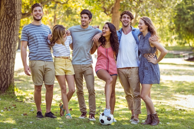 Happy friends in the park with football