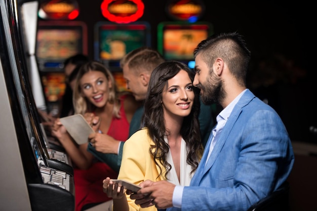 Happy Friends Playing Arcade Machine in a Casino