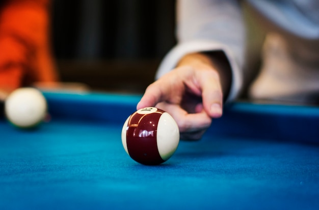 Happy friends playing pool together