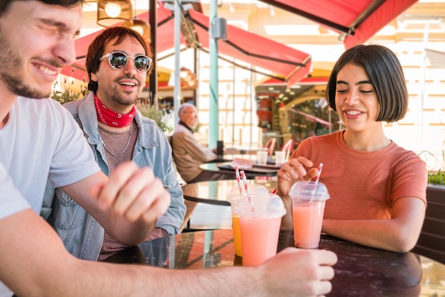 Happy friends sitting at restaurant