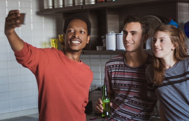 Happy friends taking selfie indoors