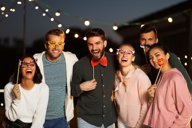 happy friends with party props at rooftop