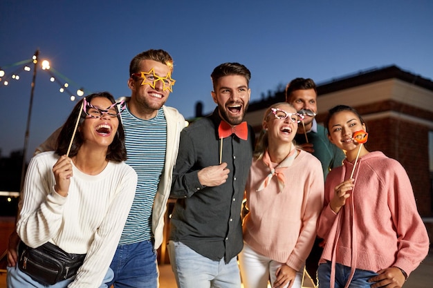 happy friends with party props at rooftop