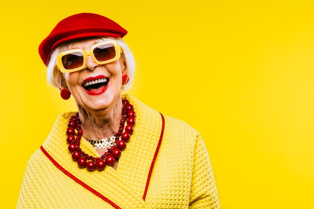 Happy and funny cool old lady with fashionable clothes portrait on colored background  Youthful grandmother with extravagant style concepts about lifestyle seniority and elderly people