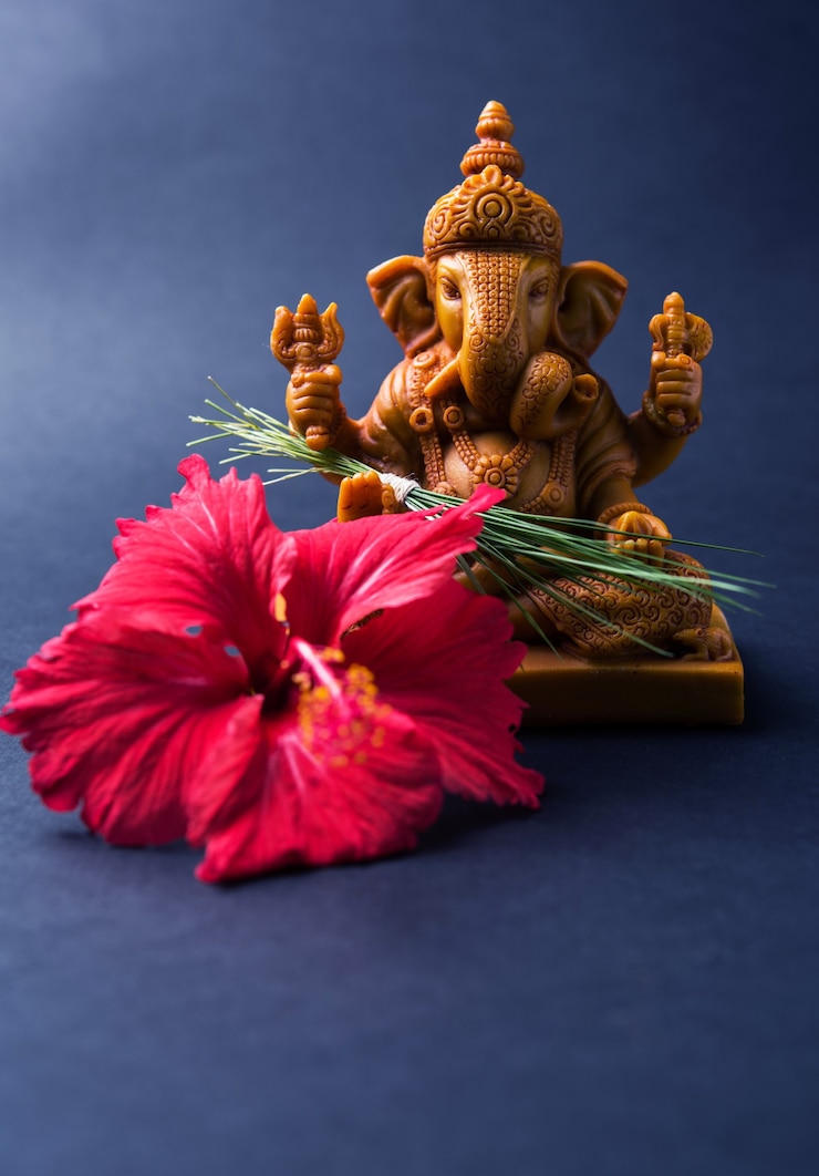 Photo happy ganesh chaturthi greeting card showing photograph of lord ganesha idol with pooja or puja thali, bundi laddu/modak, durva and hibiscus or jasvand flower