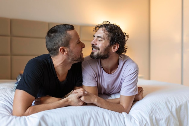 Happy gay couple having tender moments in bedroom Homosexual love relationship and gender equality concept