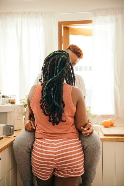 Happy gay couple kissing in the kitchen