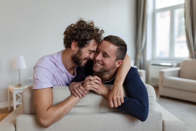 Happy gay couple lying down on the bed at home hugging and flirting LGBT gay couple love moments happiness concept