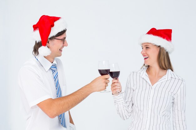 Happy geeky hipster couple drinking red wine