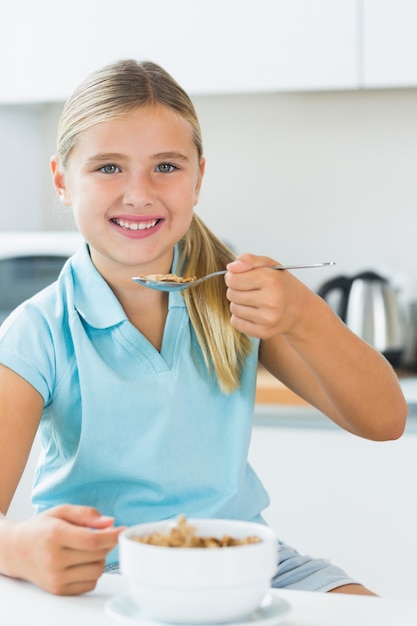 Happy girl eating cereal