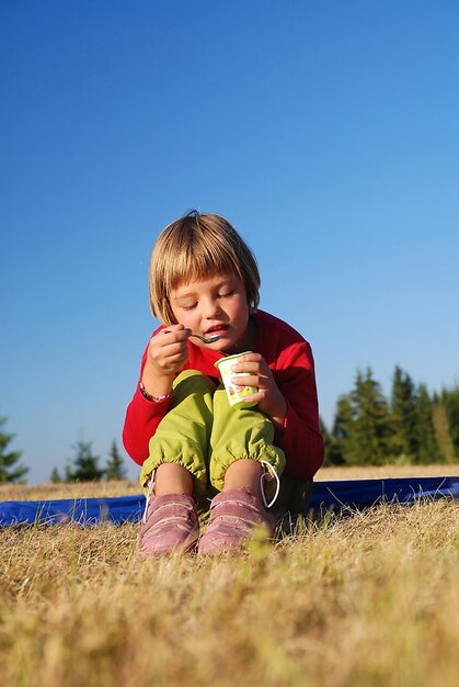 happy girl eating healthy food in nature