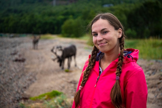 happy girl experiences close encounter with wild reindeer in norway, wildlife of norway