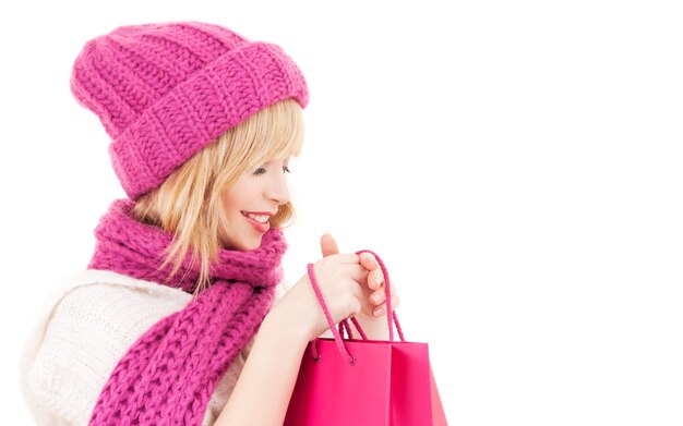 happy girl in hat with pink shopping bags