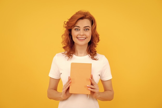 Photo happy girl hold planner on yellow background education