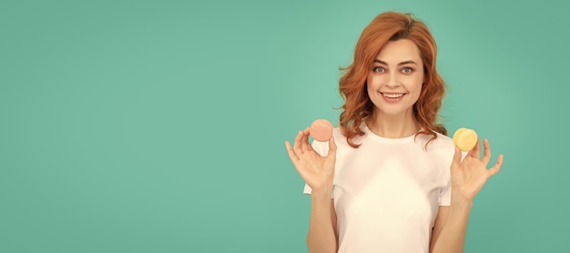 Happy girl hold sweet macaron french cookie on blue background Woman isolated face portrait banner with mock up copyspace