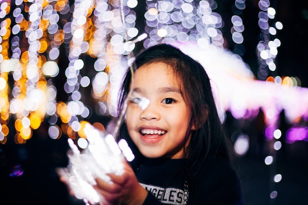 Happy girl Holding a light on a New Year's Eve