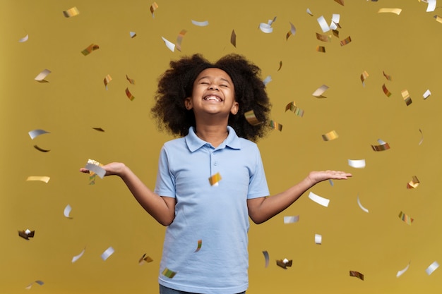 happy girl jumping surrounding by confetti